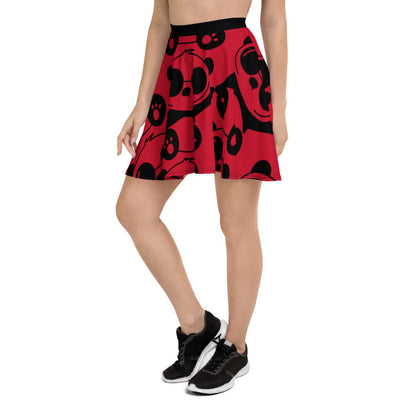 Woman wearing Skater-Rock N°0 with black patterns on a red background, featuring a flattering silhouette and elastic waistband.