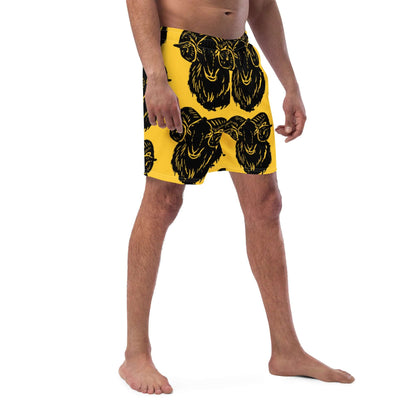 Man wearing Herren-Badehosen N°6 with ram print, showcasing black and yellow design, ideal for summer, quick-drying and breathable fabric.