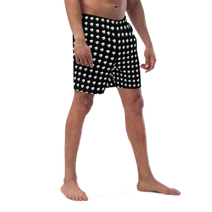 Man wearing Herren-Badehosen N°8, black swim shorts with white pattern, featuring quick-dry fabric and breathable design.