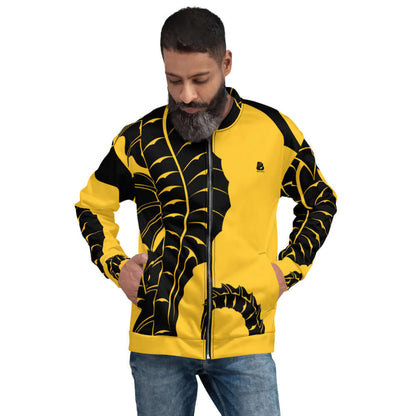 Man wearing Unisex Bomberjacke N°14 with yellow and black design, hands in pockets, standing against plain background.