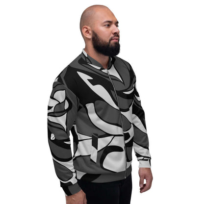 Model wearing Unisex Bomberjacke N°10 with a bold abstract pattern in black and grey, showcasing its fleece lining and versatile fit.
