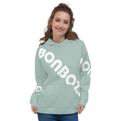 Woman wearing a light green Unisex-Kapuzenpullover N°41 with white lettering, showcasing comfort and style, perfect for cool evenings.