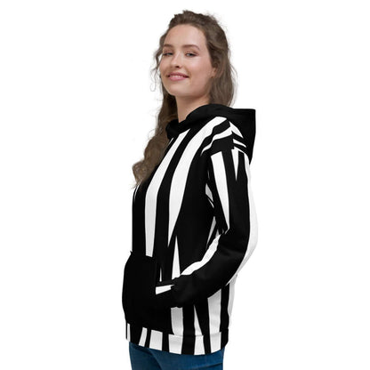 Woman wearing Unisex-Kapuzenpullover N°4 with black and white pattern, showing side view and smiling.