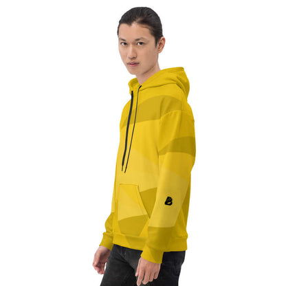 Model wearing Unisex-Kapuzenpullover N°25 in vibrant yellow with black accents and relaxed fit, perfect for a cozy evening.