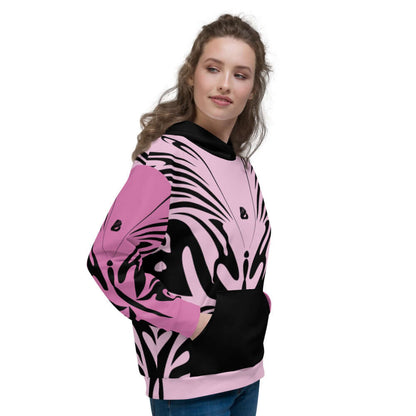 Unisex-Kapuzenpullover N°27 in pink with black abstract pattern, worn by a model, showcasing soft interior and vibrant exterior design.