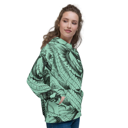 Woman wearing Unisex-Kapuzenpullover N°47 with vibrant print, showcasing soft fabric on green background, relaxed fit for cool evenings.