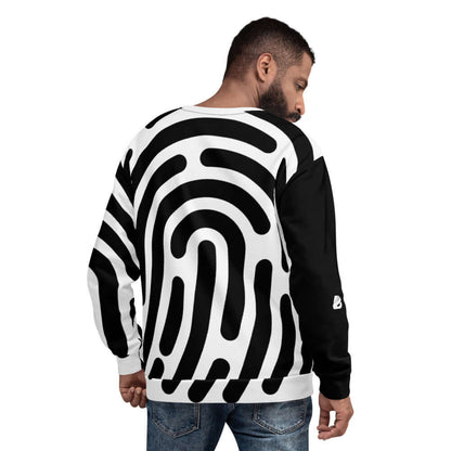 Man wearing Unisex-Pullover N°1 with bold black and white abstract design, showcasing high-quality fabric and detailed craftsmanship.