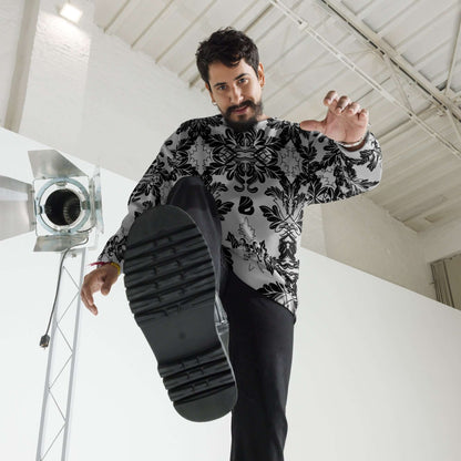 Man wearing Unisex-Pullover N°28 with intricate design in a modern studio setting.