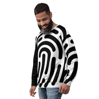 Man wearing black and white patterned Unisex-Pullover N°1 with modern design, showcasing stylish and unique full-print craftsmanship.