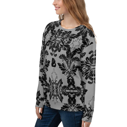 Woman wearing Unisex-Pullover N°28 with intricate black floral pattern, showcasing full print design on soft, brushed fleece material.