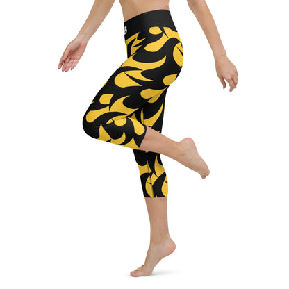 Woman wearing Yoga-Capri-Leggings N°2 in black and yellow design, featuring a high waistband and soft, stretchy fabric for comfortable movement.