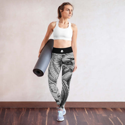Woman wearing Yoga-Leggings N°15 with dragon design holding a yoga mat, showcasing comfort and style.