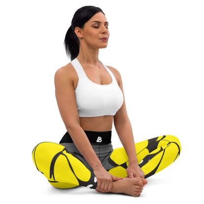 Woman in meditation pose wearing Yoga-Leggings N°41, featuring yellow and black pattern, super soft and stretchy with high waistband.