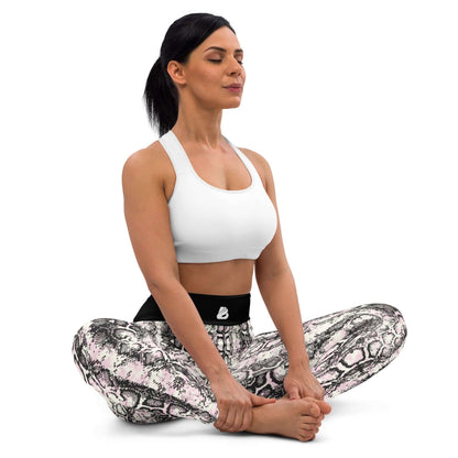 Woman meditating in Yoga-Leggings N°42 with snakeskin pattern, wearing a white sports bra, showcasing comfort and flexibility of the leggings.