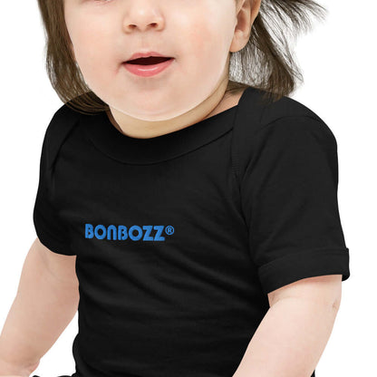 Baby wearing Kurzärmliger Baby-Einteiler N°0, black, with comfortable neckline and playful print, 100% cotton.