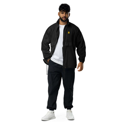 Man wearing Basic-Unisex-Windbreaker N°0, black, lightweight and durable, with zip closure and elastic cuffs for outdoor activities.