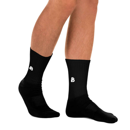 Person wearing black Socken N°10 with ribbed leg and padded sole, showcasing vibrant non-fading print.
