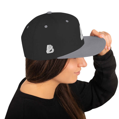 Woman wearing Snapback-Cap N°1 with classic fit and flat brim, side view.