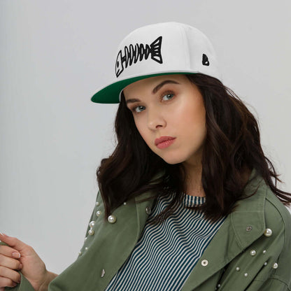 Young woman wearing Flat Bill-Cap N°2 with fish graphic and green undervisor, showcasing trendy style and comfort in a casual outfit.