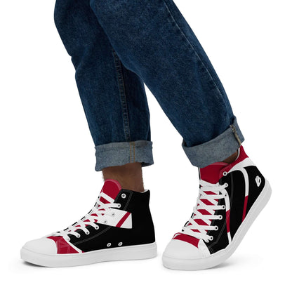 Person wearing High-Top Leinenschuhe für Herren N°4, black and red canvas sneakers with white laces, denim jeans rolled up at cuffs.