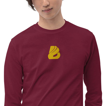 Model wearing Herren-Langarmshirt N°2, maroon with yellow logo, featuring ribbed cuffs and classic fit for cooler days.