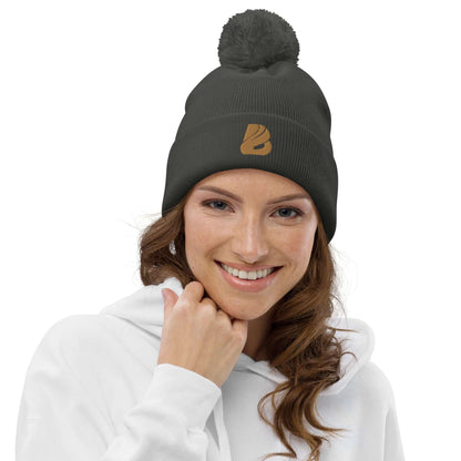 Woman wearing Bommel-Beanie N°0 in dark color with pom-pom, made from 100% soft acrylic, ideal for cozy fall and winter days.