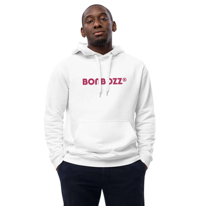 Man wearing white hoodie with "BON BOZZ" print, hands in pockets, showcasing comfortable streetwear fashion.