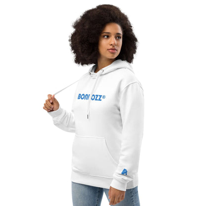 Woman wearing Hochwertiger Öko Kapuzenpullover N°7 in white with blue logo and front pocket, showcasing eco-friendly fashion.