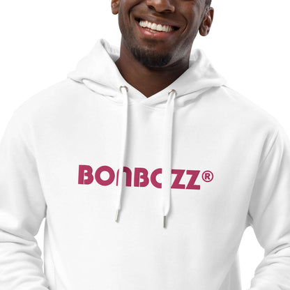 Person wearing a white hoodie with "BOMBOZZ" logo, smiling, showing casual streetwear fashion.