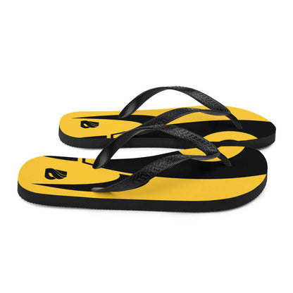 Flip-Flops N°6 in yellow and black with comfortable rubber soles and black Y-shaped straps, perfect for summer adventures.