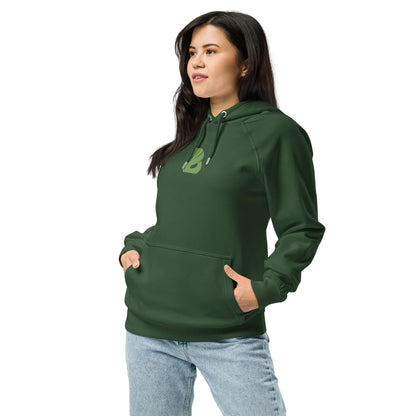 Model wearing Unisex Bio-Raglan-Hoodie N°2 in dark green with casual jeans, showcasing comfortable and stylish fit.