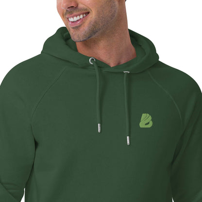 Unisex Bio-Raglan-Hoodie N°0 in green on model, showcasing comfort and style with adjustable drawstrings and stylish logo.