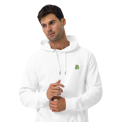 Model wearing Unisex Bio-Raglan-Hoodie N°0 in white with green logo indoors.