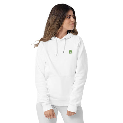 Woman wearing a white Unisex Bio-Raglan-Hoodie N°0 with green logo, showcasing casual and comfortable fashion.