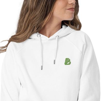 Woman wearing Unisex Bio-Raglan-Hoodie N°0 with soft interior and green logo, styled for comfort and versatility.