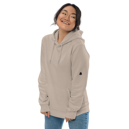 Person wearing Umweltfreundlicher Unisex-Kapuzenpullover N°1 in beige showcasing eco-friendly fashion style.
