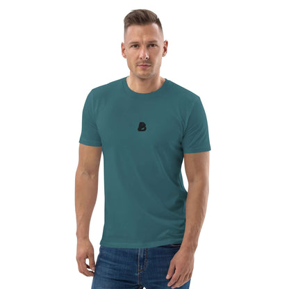 Unisex-Bio-Baumwoll-T-Shirt N°0 in teal, 100% organic cotton, worn by a model standing against a white background for eco-friendly fashion statement.