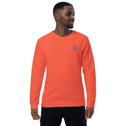 Model wearing the Unisex Bio-Raglan-Pullover N°1 in orange, made from 100% organic cotton, featuring brushed fleece lining.