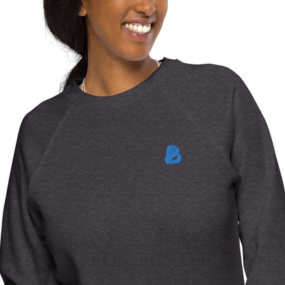 Woman wearing Unisex Bio-Raglan-Pullover N°1, dark grey with blue logo, emphasizes comfort and style with 100% cotton