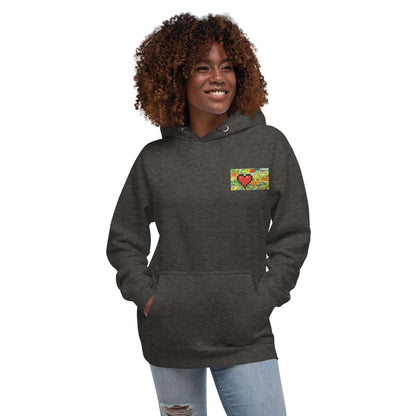 Model wearing Unisex-Kapuzenpullover N°45 with colorful heart design, showcasing kangaroo pocket and cozy hood.