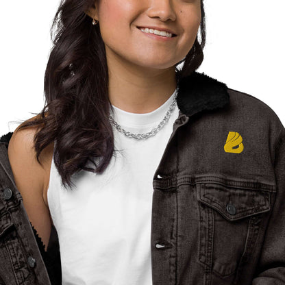 Person wearing a Unisex Sherpa Jeansjacke N°0 in black denim with sherpa lining, featuring eco-friendly recycled materials.